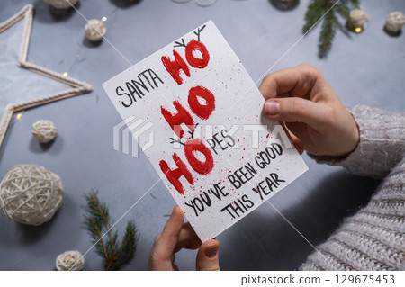 Storytelling of creating craft Christmas greeting card holiday present. Tactile hand-on activity. Master class progress of creative me-made gifts. Seasonal domestic life micro moment hobby.  129675453