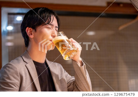 Izakaya: A man enjoying a drink alone 129675479