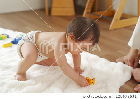 Infants and toddlers fascinated by educational toys 129675631