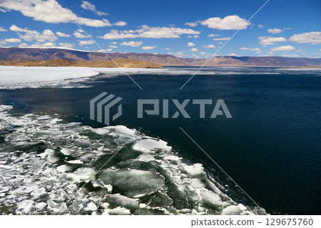 Spring landscape of Baikal Lake in sunny May day. Ice drift Spring landscape of Baikal Lake in sunny May day. Ice drift 129675760