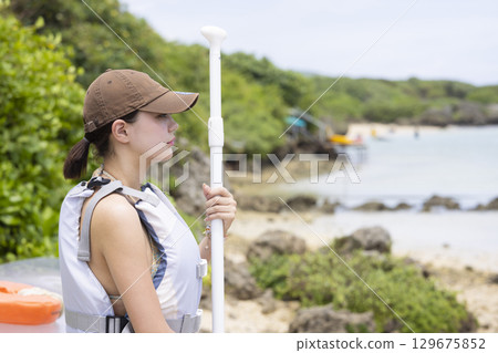 Cute woman enjoying SUP Cute woman enjoying SUP 129675852