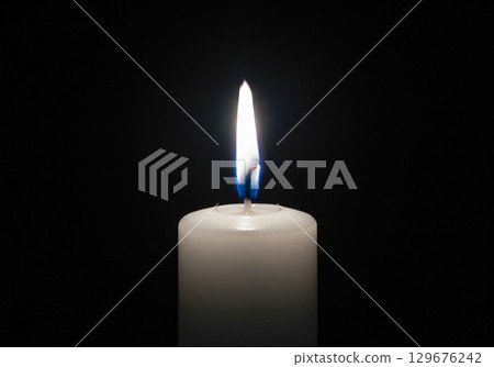 Single Lit Candle in the Dark, White Pillar Candle Flame Single Lit Candle in the Dark, White Pillar Candle Flame 129676242