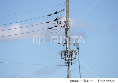 Telephone pole in the blue sky Telephone pole in the blue sky 129676680