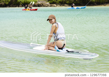 Cute woman enjoying SUP 129677398