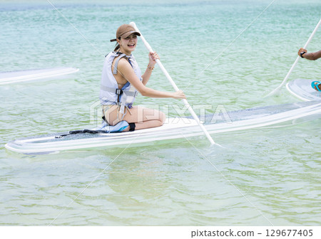 Cute woman enjoying SUP 129677405