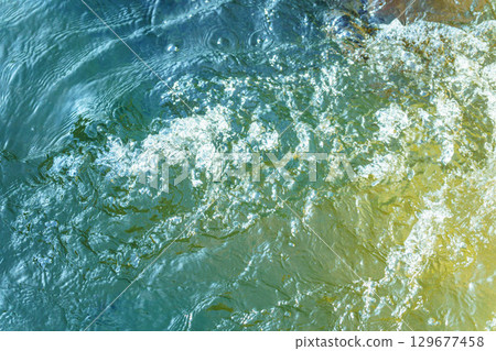 Light reflected on the surface of the rapids 129677458