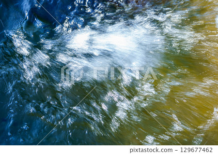 Light reflected on the surface of the rapids 129677462