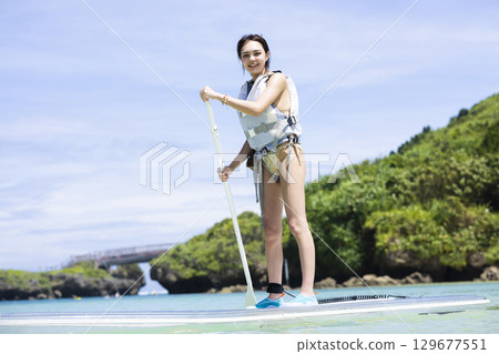 Cute woman enjoying SUP 129677551