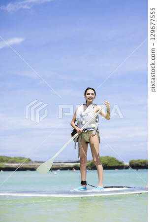 Cute woman enjoying SUP 129677555