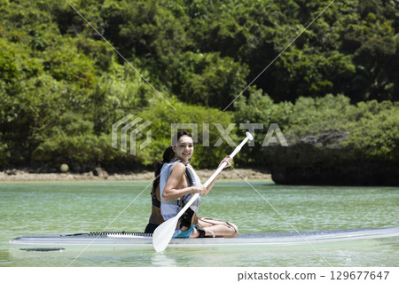 Cute woman enjoying SUP 129677647