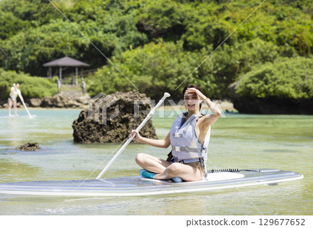 Cute woman enjoying SUP 129677652