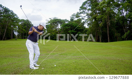 Golfers are playing golf in the evening golf course golf backglound. Golfers are playing golf in the evening golf course golf backglound. 129677888