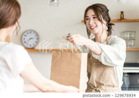 在咖啡館和餐廳向顧客分發外帶產品的女性咖啡館的容量 在咖啡館和餐廳向顧客分發外帶產品的女性咖啡館的容量 129678934