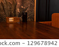 A table in a lounge bar partially served, dim warm light and copy space. 129678942