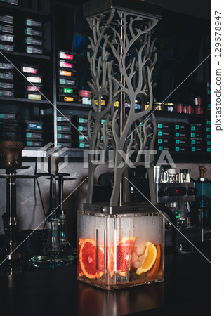 Grapefruit hookah and classic hookahs at the bar in the lounge bar, vertical image. 129678947