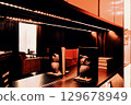 Decorative shelving and lounge bar interior through reflection in the mirror, blur stylization. 129678949