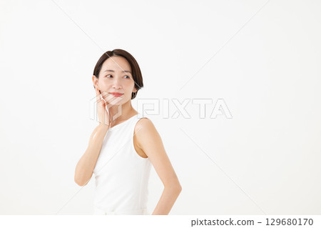 Middle-aged woman with hand on cheek Middle-aged woman with hand on cheek 129680170
