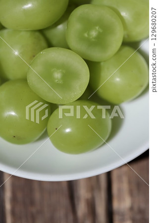 Japanese Shine Muscat grapes, removed from the bunch and cut in half Japanese Shine Muscat grapes, removed from the bunch and cut in half 129680207