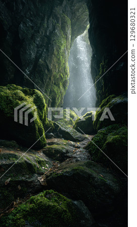 Mossy rock hidden passage waterfall cave nature sunlight mysterious green 129680321