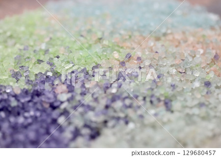 Aromatic bath salts made from various scented colored bath salts lightly mixed and flattened Aromatic bath salts made from various scented colored bath salts lightly mixed and flattened 129680457