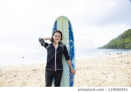Surfboard and ladies 129680941