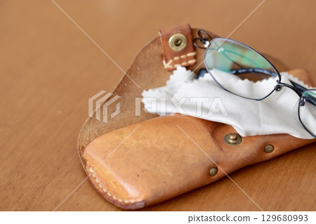 Reading glasses and a worn-out leather glasses case Reading glasses and a worn-out leather glasses case 129680993