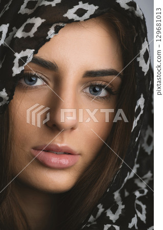Close-up beautiful woman portrait with scarf on her head Close-up beautiful woman portrait with scarf on her head 129681013