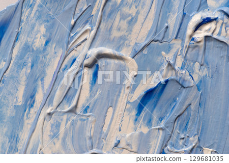 A background made of mixed blue and white paint 129681035