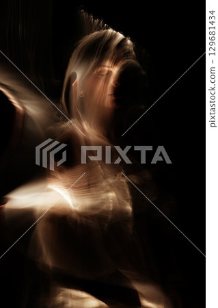 Light trails of light painting golden vivid color woman portrait 129681434