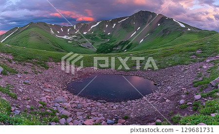 Alpine Tarn Reflects Dramatic Sunset Sky Amidst Rocky Terrain an 129681731