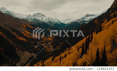 Autumnal Valley Vista: Snow-Capped Peaks and Golden Aspen Trees 129681871