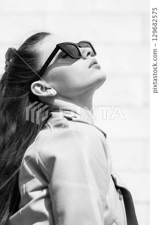 Beautiful woman with long dark hair and sunglasses outdoor close-up portrait Beautiful woman with long dark hair and sunglasses outdoor close-up portrait 129682575
