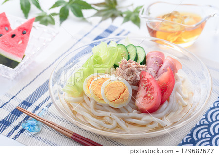 Perfect for summer, this refreshing glass bowl of salad udon is a colorful cold noodle dish with vegetables, eggs, and ham. Perfect for summer, this refreshing glass bowl of salad udon is a colorful cold noodle dish with vegetables, eggs, and ham. 129682677