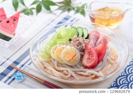 Perfect for summer, this refreshing glass bowl of salad udon is a colorful cold noodle dish with vegetables, eggs, and ham. Perfect for summer, this refreshing glass bowl of salad udon is a colorful cold noodle dish with vegetables, eggs, and ham. 129682679