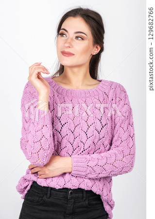 Beautiful woman with pink sweater and black jeans portrait 129682766