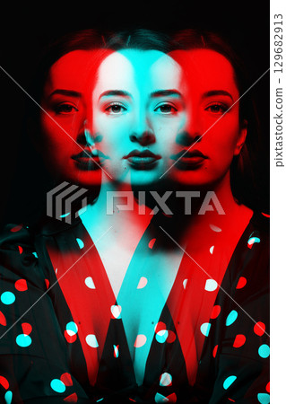 Beautiful woman with long dark hair studio portrait in rgb color split effect Beautiful woman with long dark hair studio portrait in rgb color split effect 129682913
