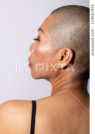 Woman with shaved head portrait 129682959