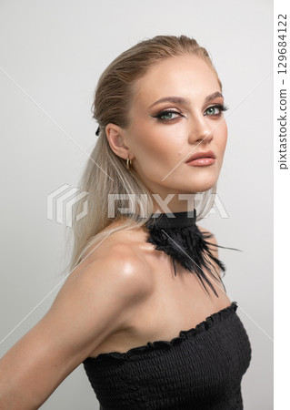 Beautiful woman with smokey makeup close up studio portrait 129684122
