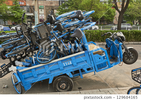 Tricycle overloaded with shared blue public bicycles in Beijing, China 129684165