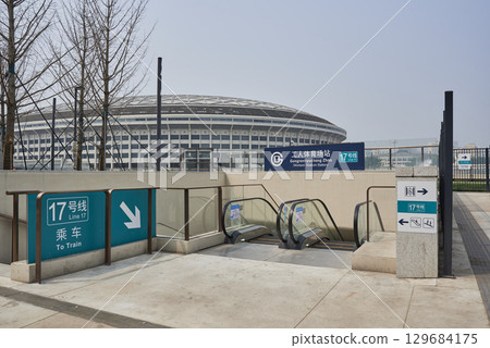 Entrance to the Workers Stadium subway station with stadium in the background in Chaoyang district of Beijing, China 129684175