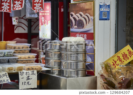 Street food stall with steamed buns and pastries in metal steamers in Beijing, China Street food stall with steamed buns and pastries in metal steamers in Beijing, China 129684207