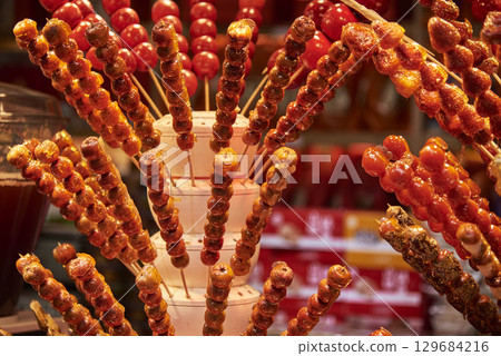 Candied fruit skewers displayed in a market setting in Wangfujing commercial street in Beijing, China 129684216