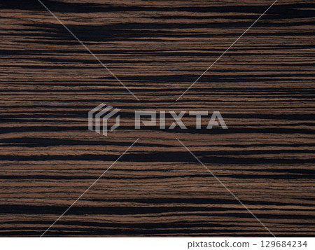 Elegant ebony wood with rich dark brown hues and striking black streaks 129684234