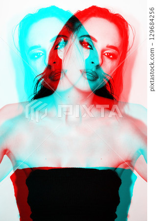 Beautiful woman with smokey make-up close-up studio portrait in RGB color split effect 129684256