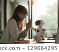 一位日本年輕女子微笑著與人工智慧機器人交談 129684295