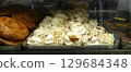 Freshly baked meringues with hazelnut crumbs on top. 129684348