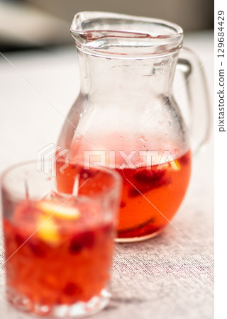 Fruit-Infused Beverage in Glass Pitcher and Glass Fruit-Infused Beverage in Glass Pitcher and Glass 129684429