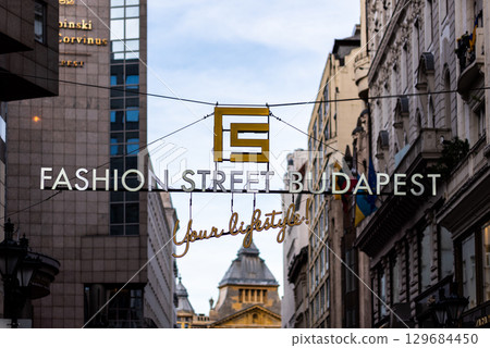 Hanging sign of Fashion Street Budapest, pedestrian street with upscale fashion boutiques in Budapest, Hungary 129684450