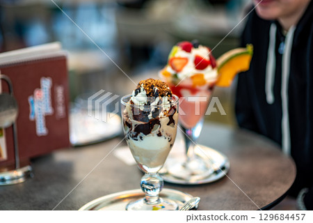 Ice Cream Sundaes with Toppings in a Cafe 129684457