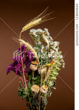 Rustic Dried Flower and Wheat Bouquet on Brown Backdrop 129684684